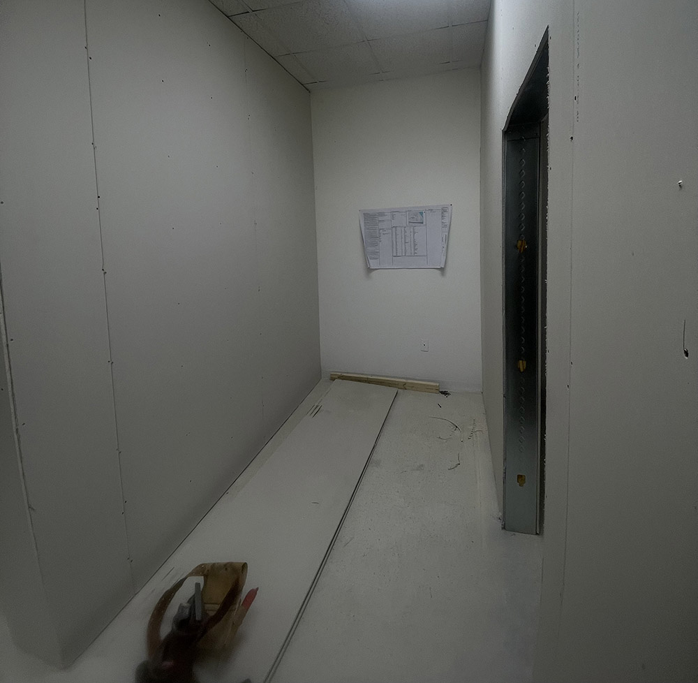 Architectural blueprint mounted on hung commercial drywall